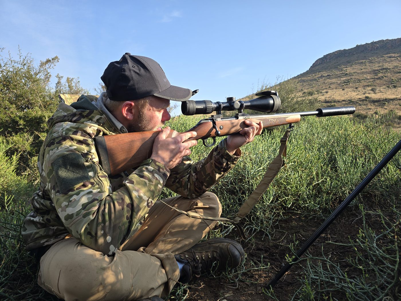 Hunter taking aim during a Karoo plains game stalk