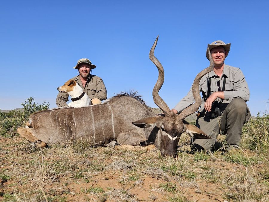 Two hunters with a heavy-horned kudu bull